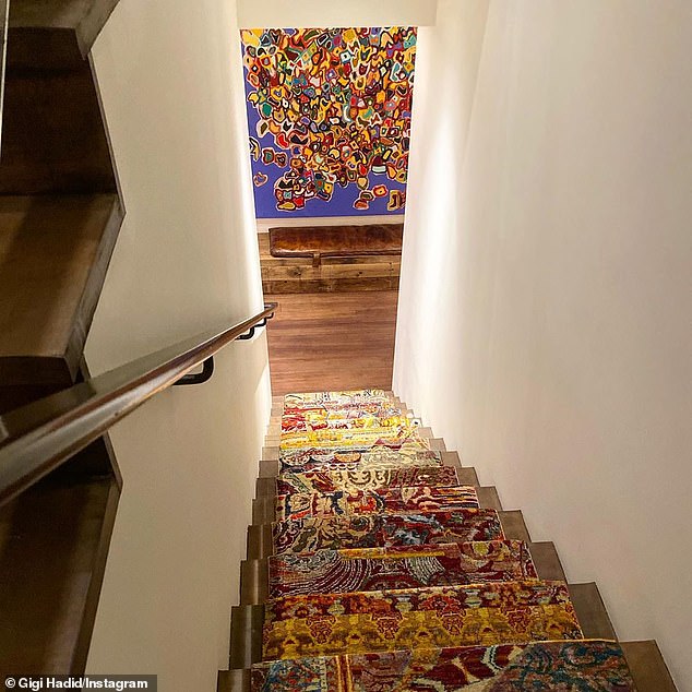 Going down: Her staircase was covered in carpet, with a different pattern for each step, culminating in a small brown bench and a blue painting from Weiner covered in abstract splotches