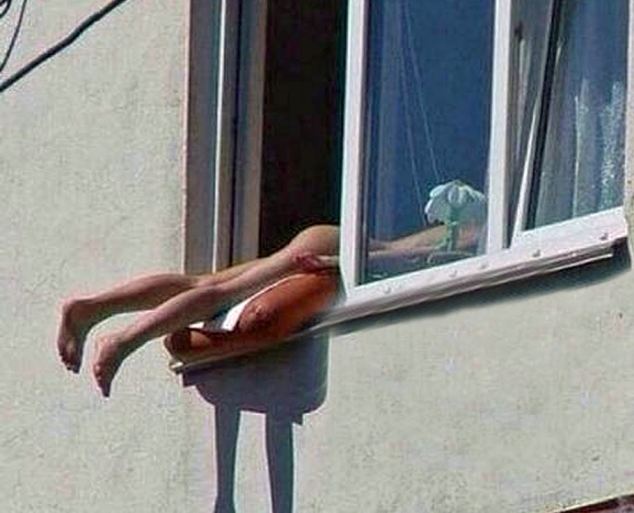 A nude woman sunbathing in the Austrian capital Vienna caused snarl ups on a major road when she positioned her naked body out of a window to get the maximum out of the sun