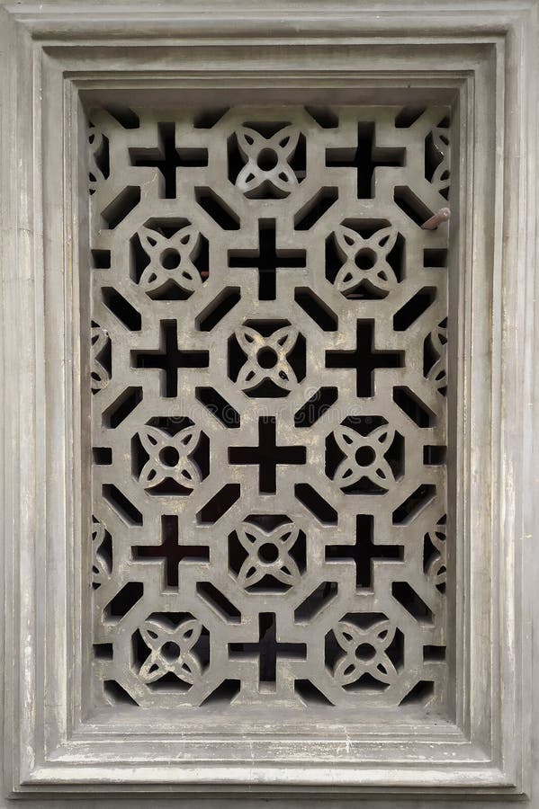 Air duct window with decorative, stone lattice. ancient concrete lattice in the window stock images
