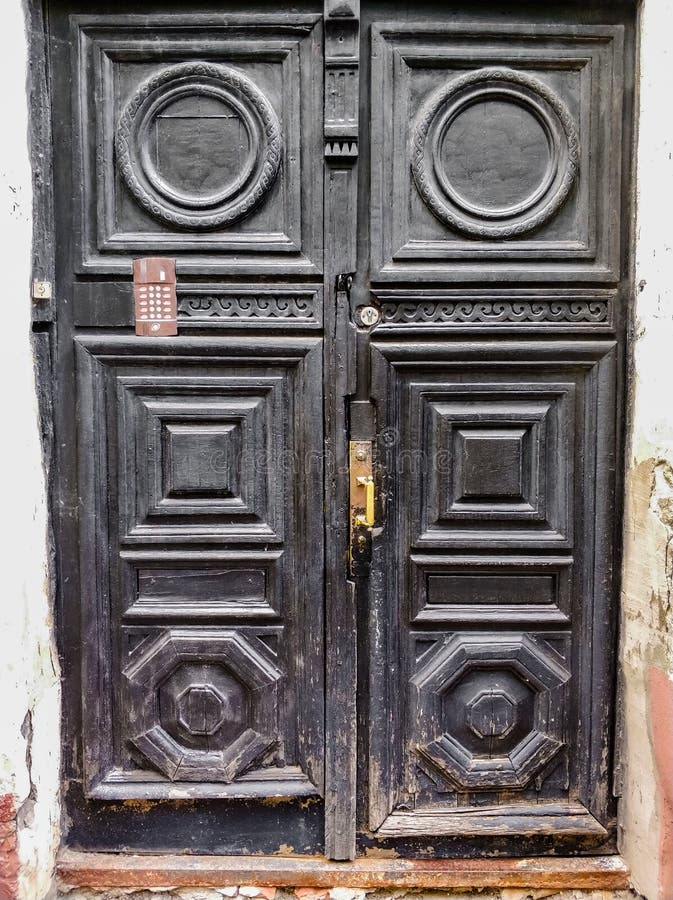 ancient wooden black doors with infill and door handle stock photo