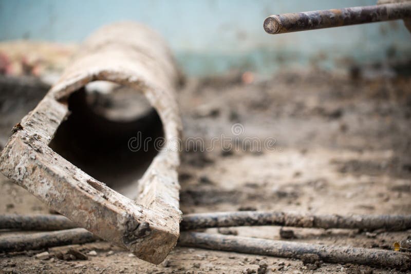 Dirty cement pipe with clay at construction site outdoor. Close up dirty cement pipe with clay at construction site outdoor stock photo