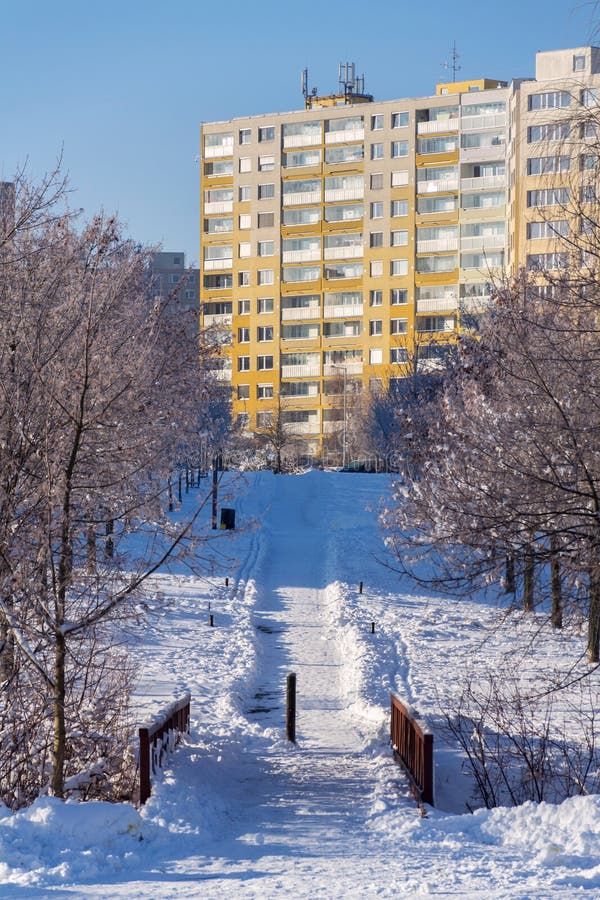 Insulated panel house apartments behind trees, high-rise block of flats, prefabricated tower blocks from concrete slabs stock photography