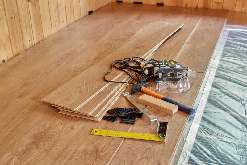 Laying laminate covering on heat-insulated floor royalty free stock image