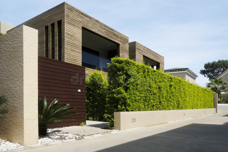 Modern houses with green plant wall stock image