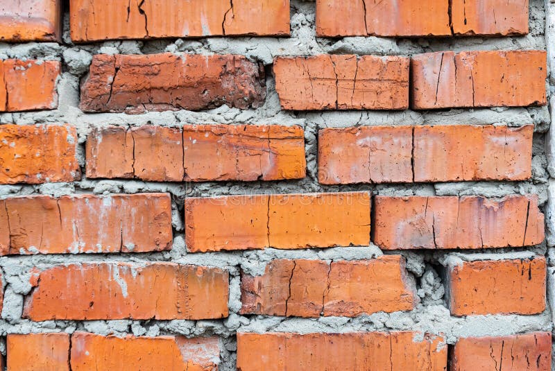 Old red brick wall with cracks of adored ceramic brick of clay and cement mortar.  royalty free stock photos