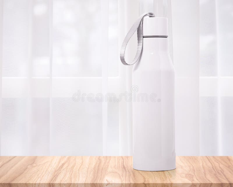 Steel bottle on curtains backdrops. Insulated drink container. Background royalty free stock images