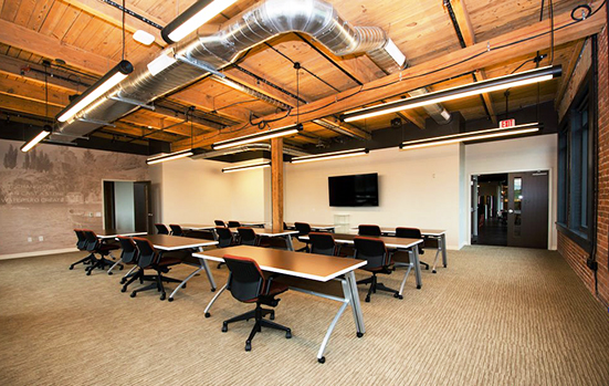 Carefully placed wireless access points, room speakers, sound-masking speakers, and structured cabling provide the connectivity and collaboration this interactive space requires while still keeping the original rustic beams in place.