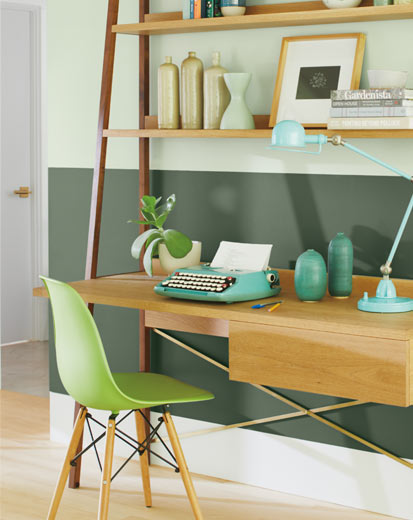 A two-tone green home office wall with green office chair