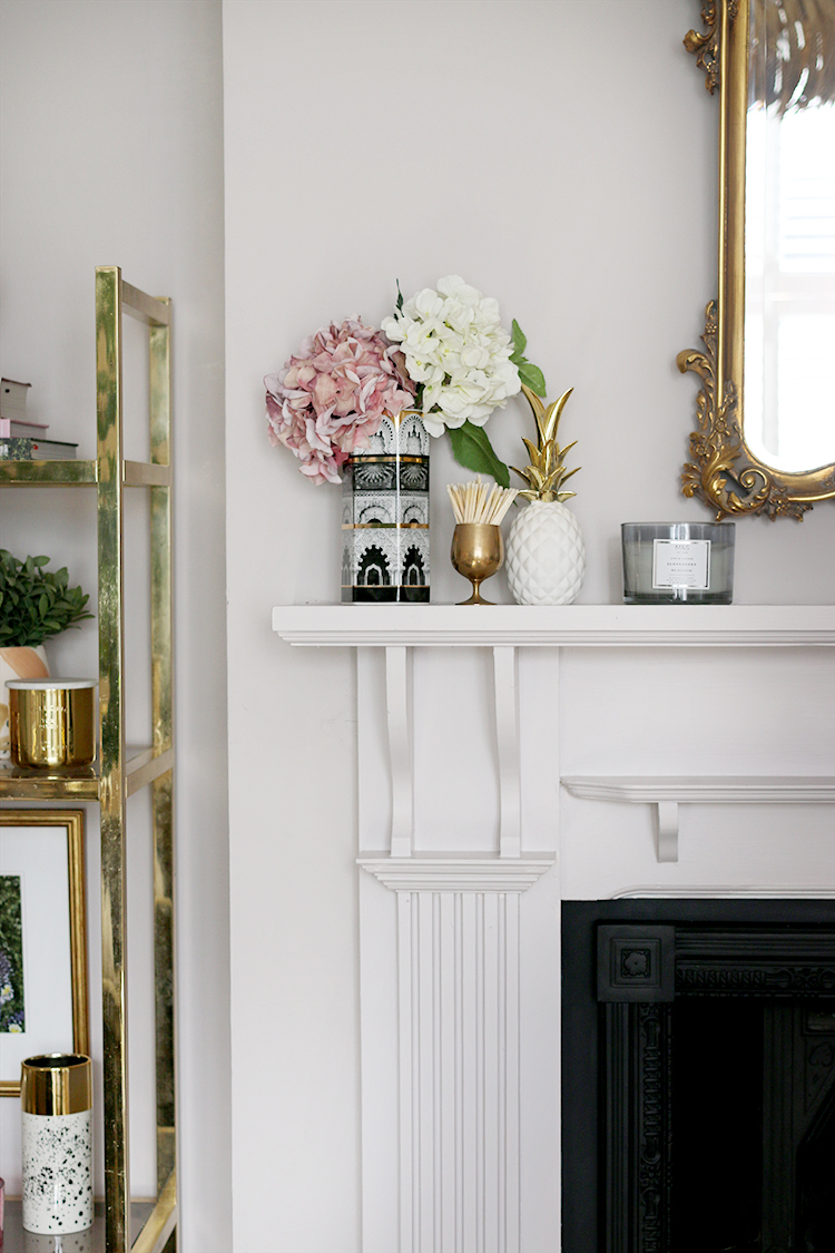 fireplace styling detail with faux hydrangeas and candles