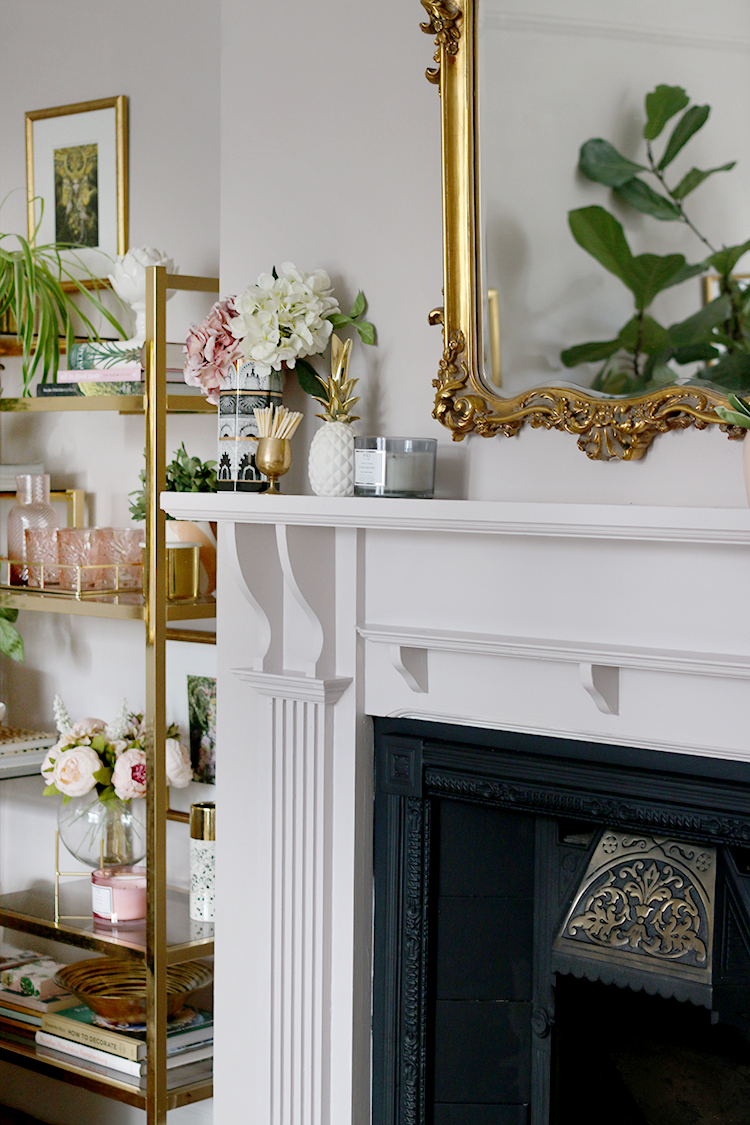 Detail of Victorian fireplace makeover with vintage gold shelving unit