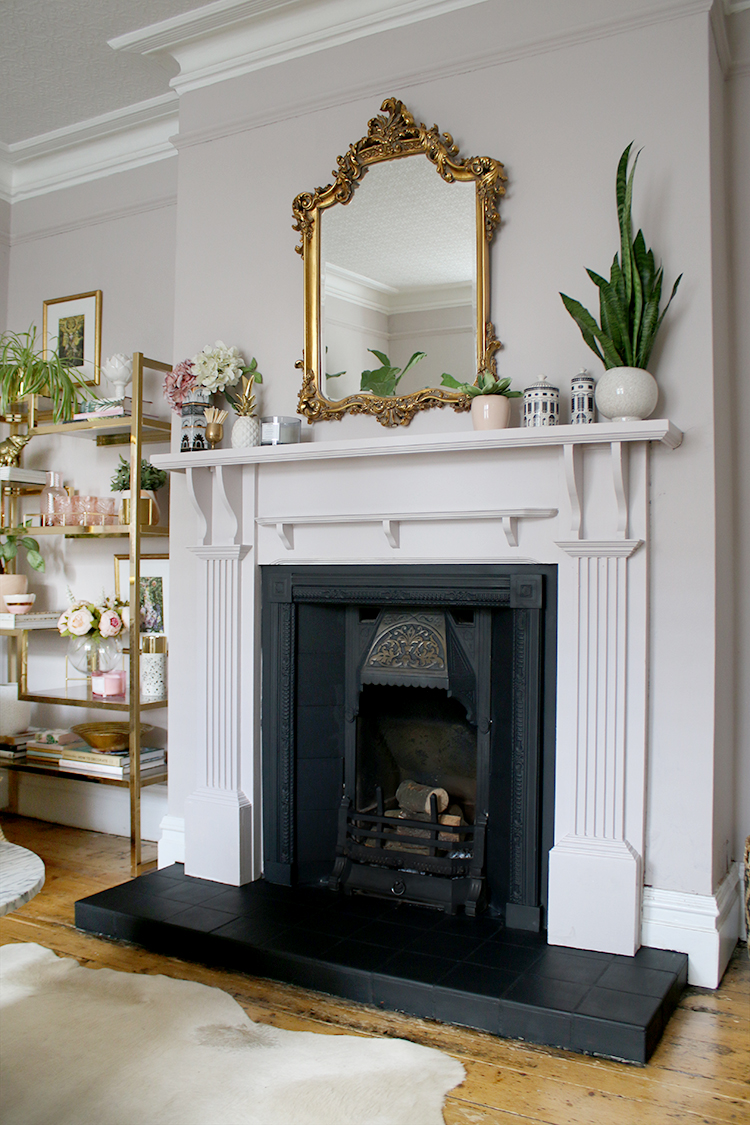 Victorian fireplace makeover in mink with ornate mirror and gold shelving unit